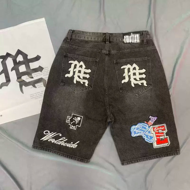 Mixed Emotion Multi‑Patch Black Denim Jorts Main Image